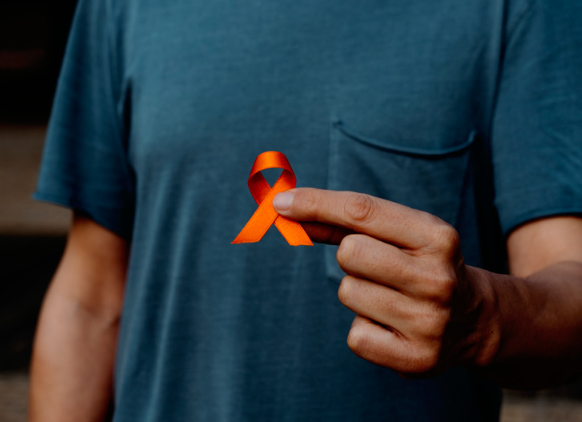 Man holding orange ribbon for multiple sclerosis