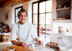 Elderly person in her kitchen baking