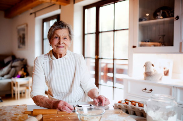 Elderly person in her kitchen baking