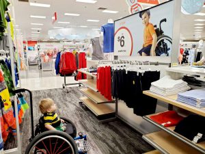 Image of Ollie in wheelchar looking at an inclusive add in Target. From Ollies World on FB