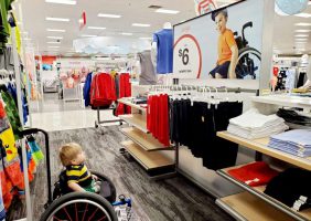 Image of Ollie in wheelchar looking at an inclusive add in Target. From Ollies World on FB