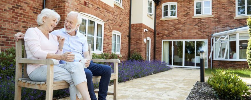 Image of ageing couple outside a Nursing Home