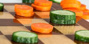 Chessboard with carrots and cucumber