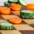 Chessboard with carrots and cucumber