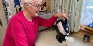 Elderly woman using the tilt to pour action of the Uccello Kettle