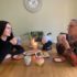 Granddaughter and grandmother sharing a conversation over a cup of tea