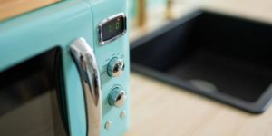 Blue Microwave beside the stovetop