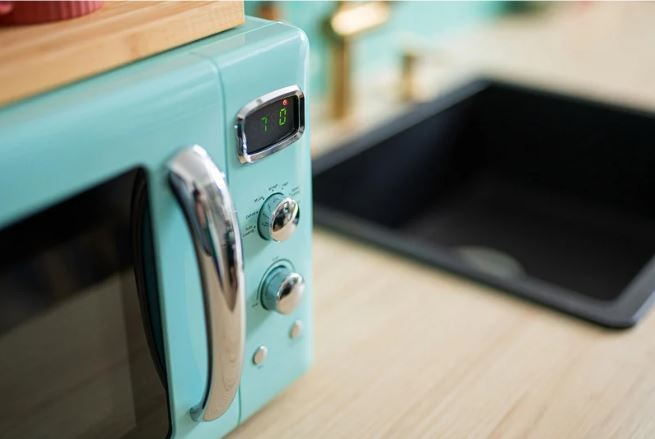 Blue Microwave beside the stovetop