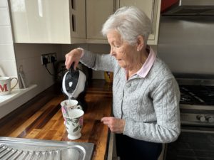 Elderly woman using the Uccello Easy Pour Kettle to make a cup of tea