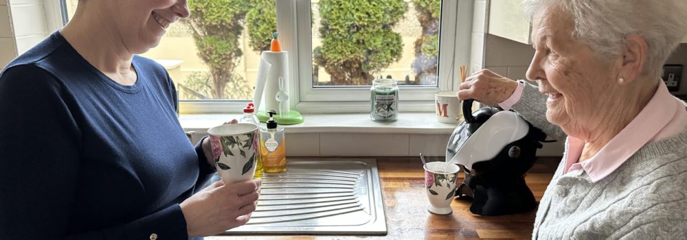 Elderly mother and daughter in the kitchen making tea with the Uccello Easy Pour Kettle